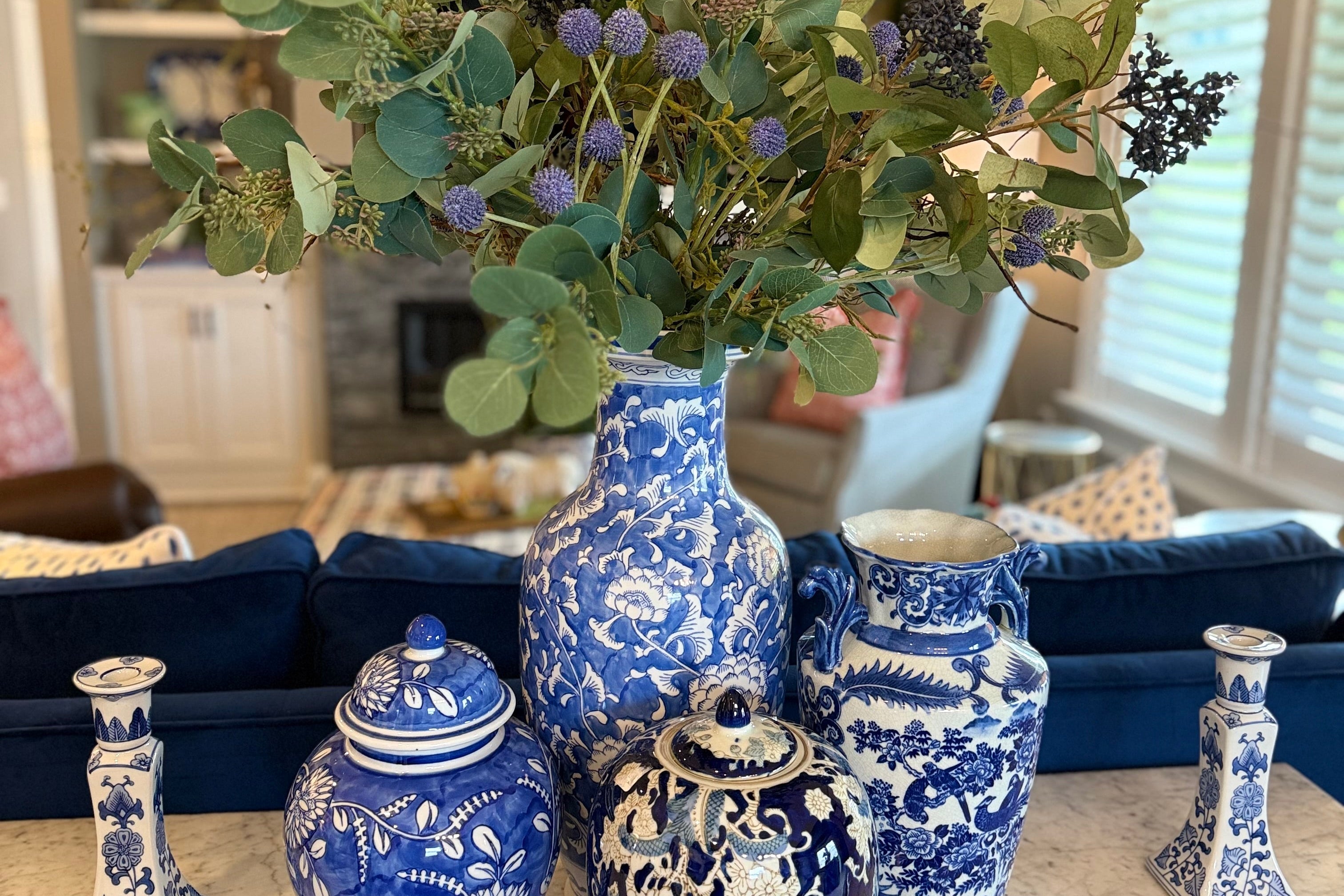 Decorative blue and white vases with floral arrangement on a table