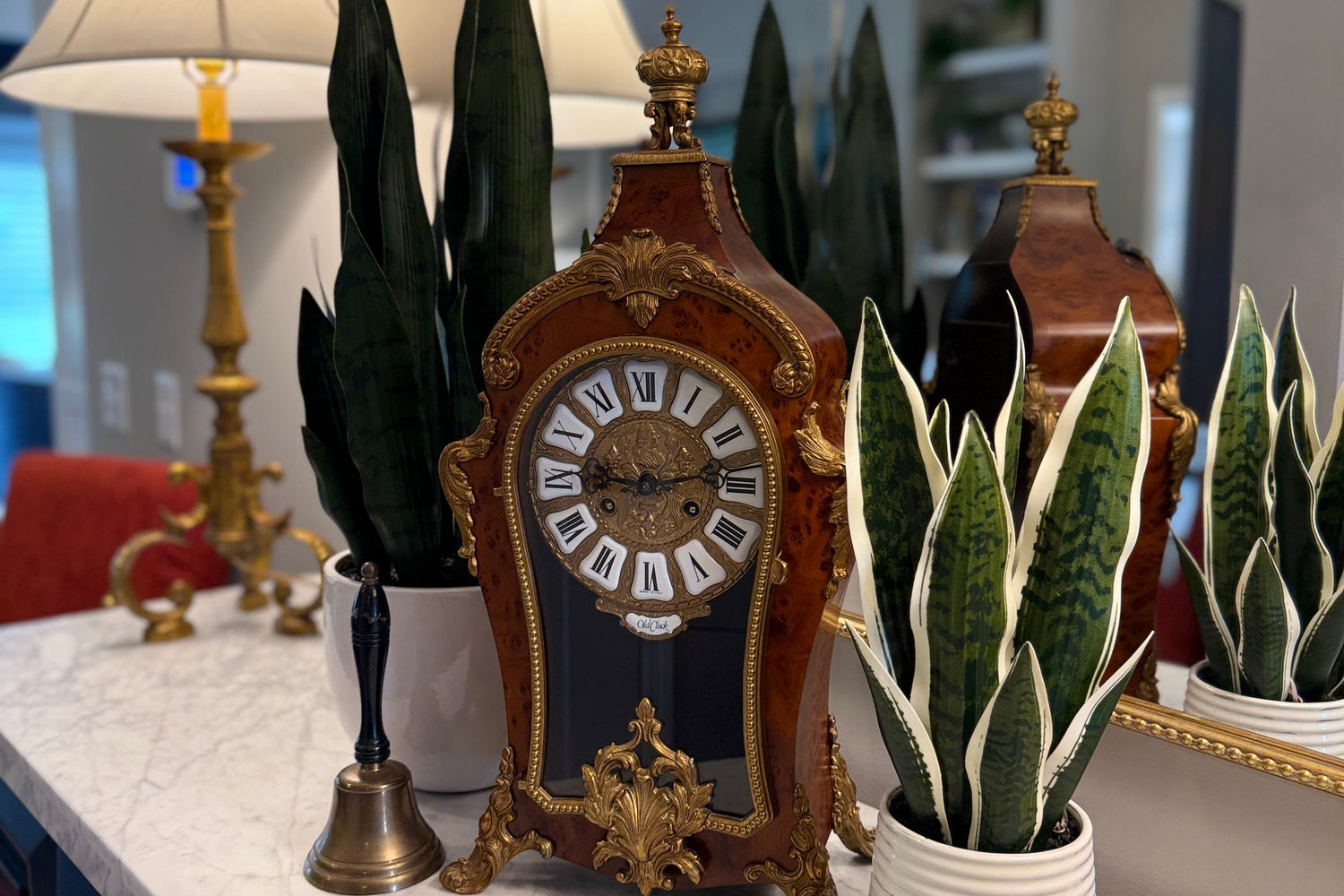 Decorative clock with plants on a marble surface