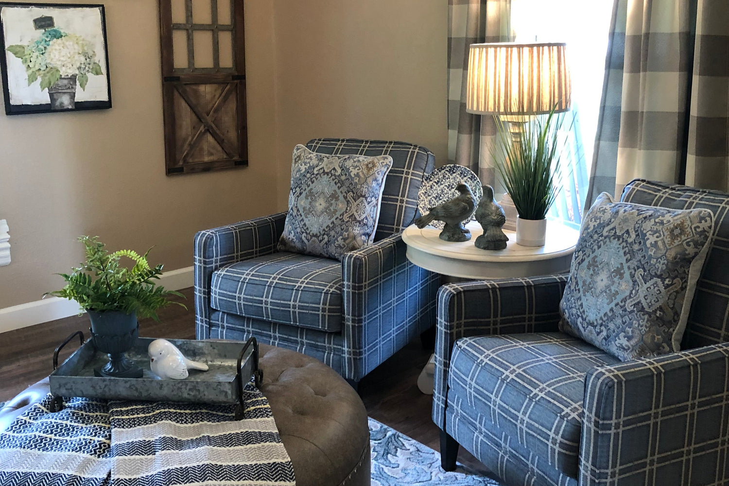 Living room with plaid curtains, patterned sofa, and decorative wall art.