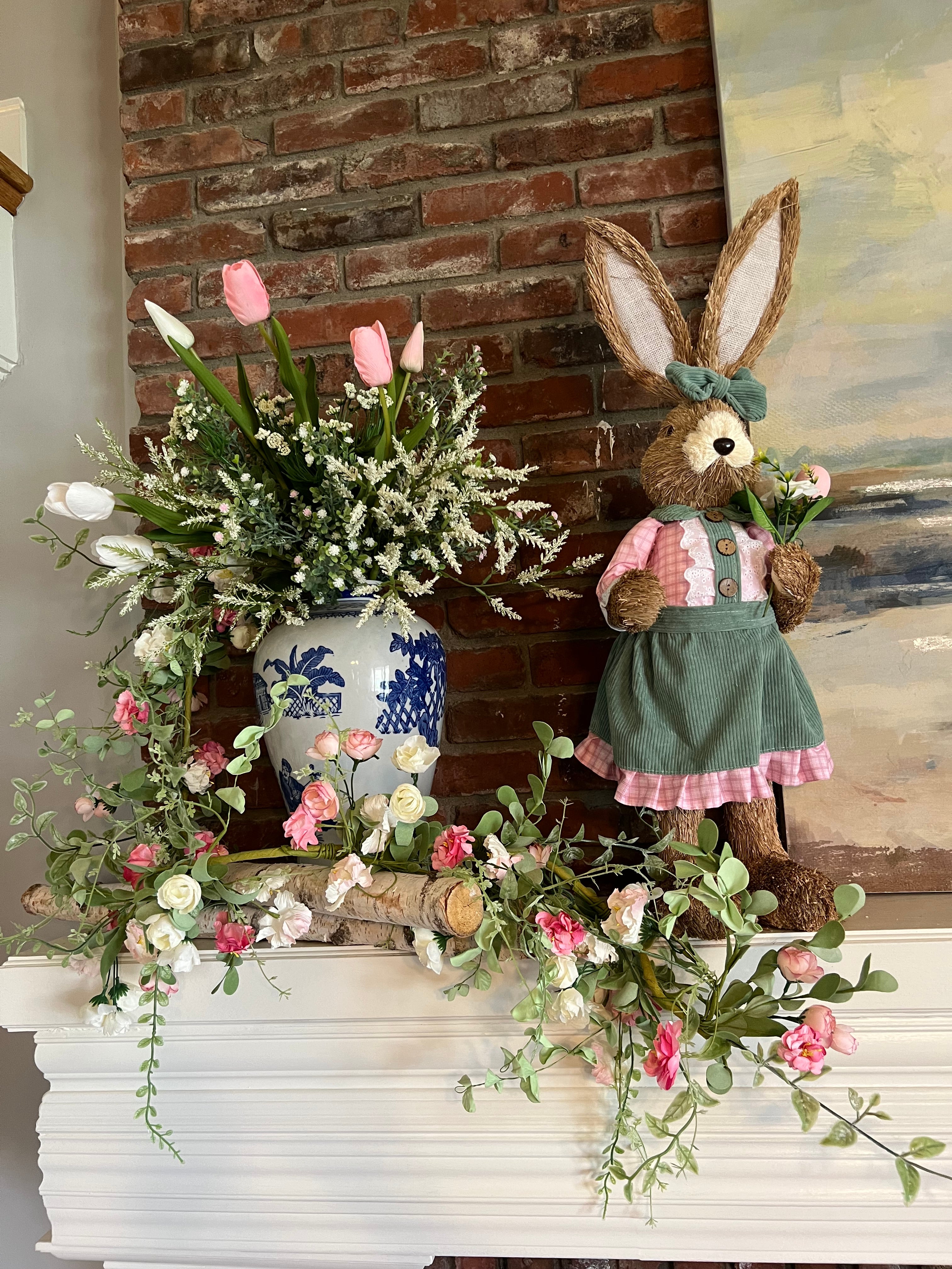 Decorative wreath with a rabbit figure and floral elements on a wall.