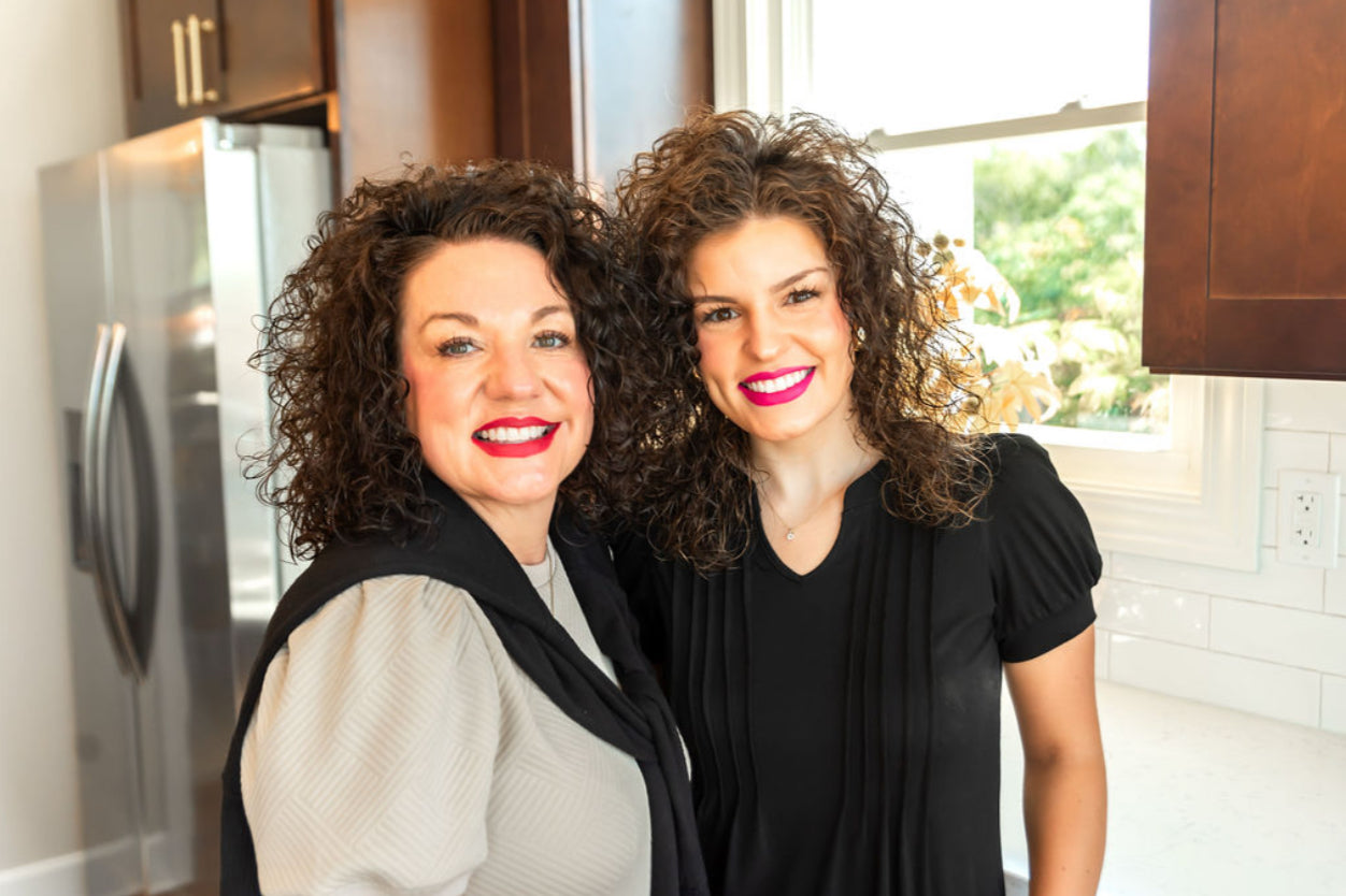 Tabitha & Lexi standing in a kitchen.